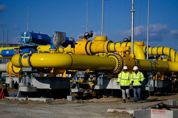 Employees walk at the construction site of a gas metering station, part of the pipeline link between Bulgaria and Greece near the village of the Malko Kadievo, on March 18, 2022. - EU member Bulgaria has been criticised for its almost total dependence on Russia for its annual consumption of about three billion cubic metres of gas. In a bid to secure alternative deliveries, the Balkan country had long planned to link its gas network to those of its neighbours -- Greece, Serbia and Romania -- but the projects were severely delayed by administrative hurdles. (Photo by Nikolay DOYCHINOV / AFP) (Photo by NIKOLAY DOYCHINOV/AFP via Getty Images)